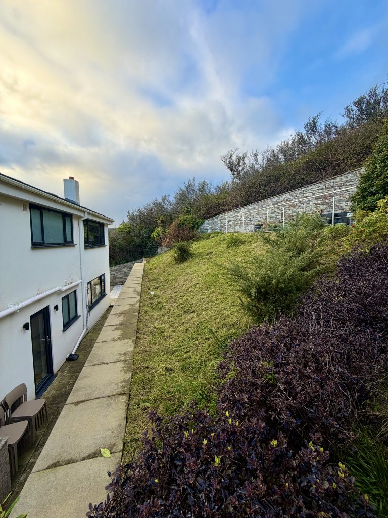 Professional steep lawn maintenance and hillside gardening service after transformation in South East Cornwall.